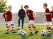 A children’s football coach watching a training session.