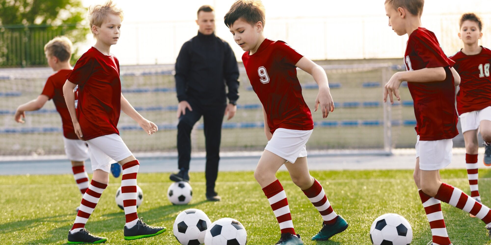 2 (92) A children’s football coach watching a training session.