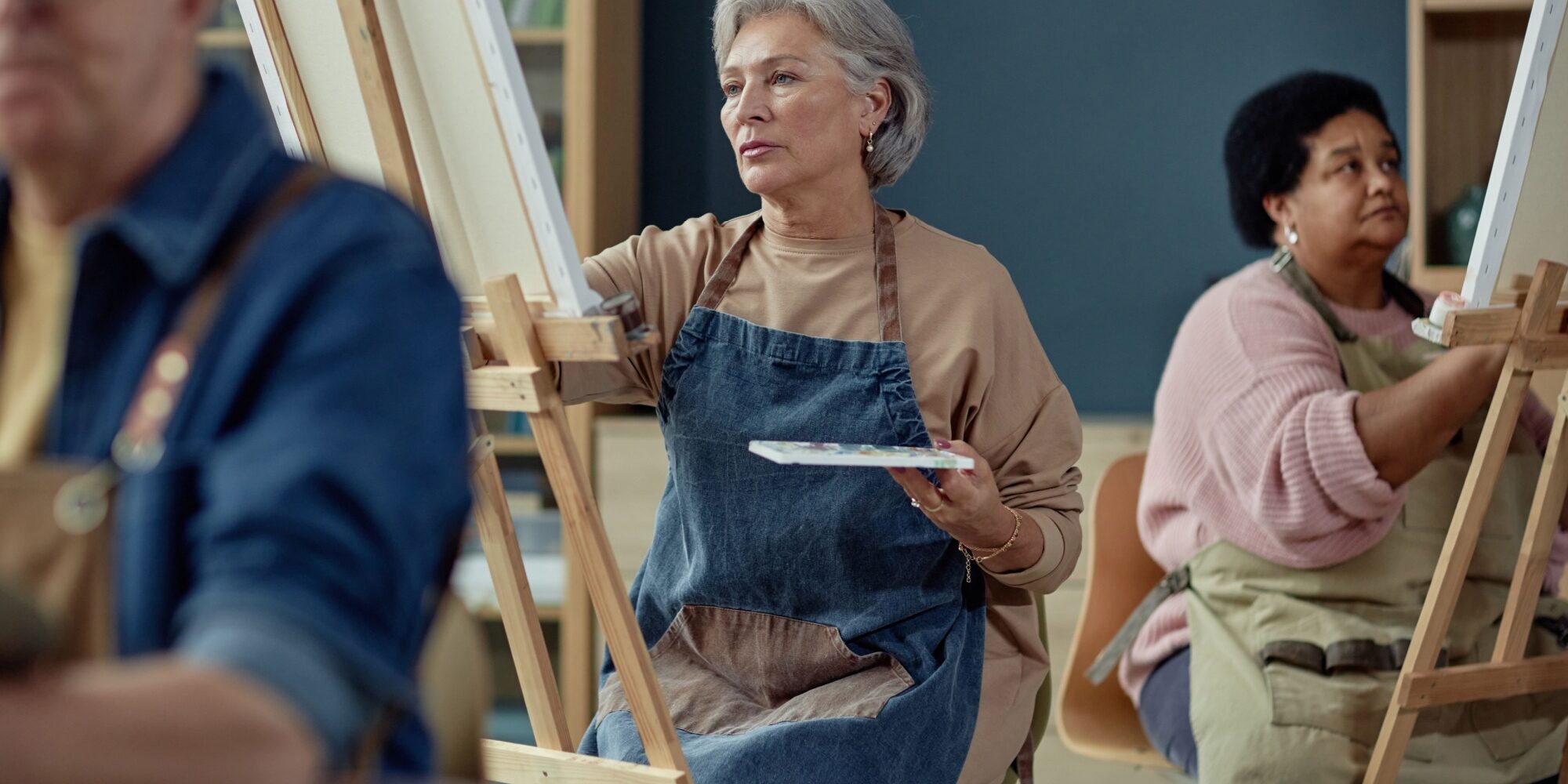 A group painting on easels in an art studio.