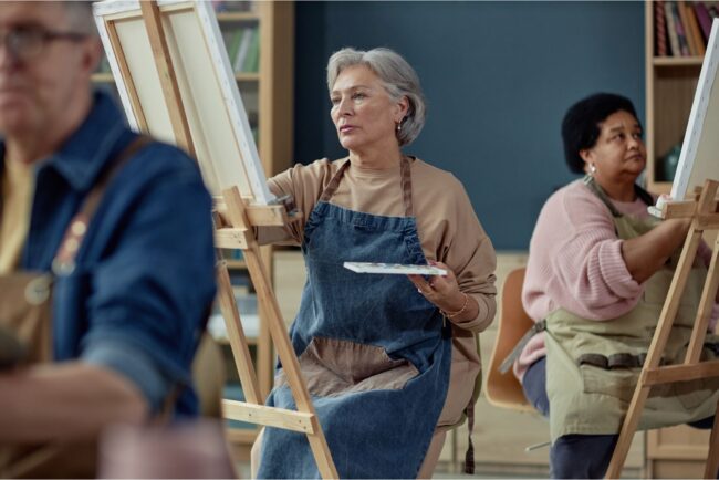 A group painting on easels in an art studio.