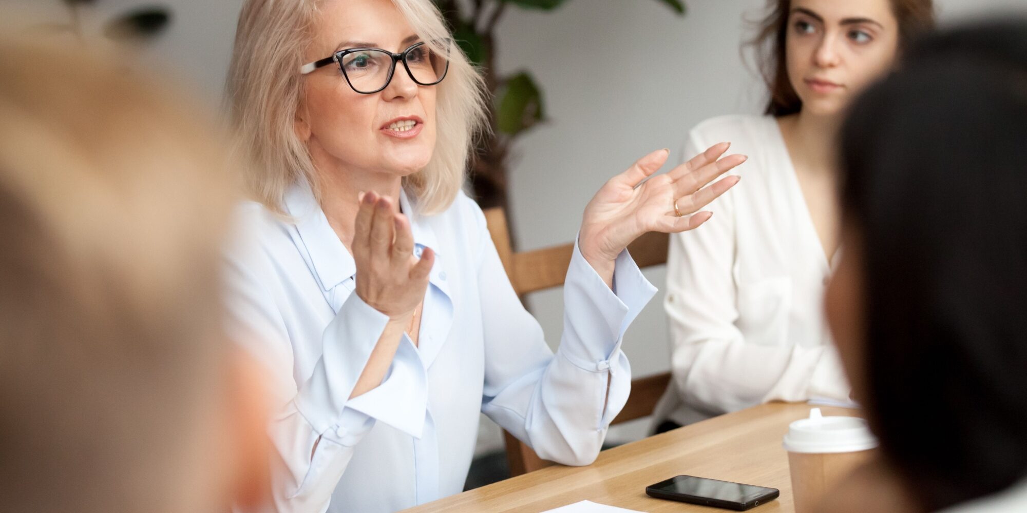 A woman talking during a work meeting.