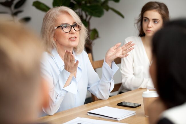 A woman talking during a work meeting.