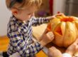 A child carving a pumpkin.