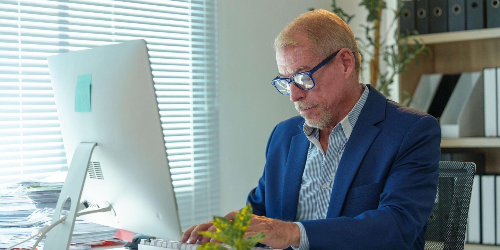 Blog 3 A man working at an office desk.