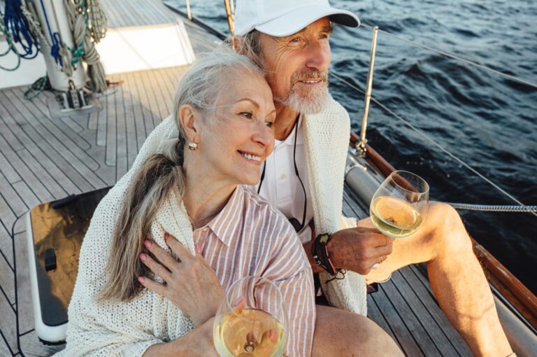 A couple sitting on a yacht deck.