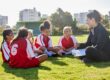 A woman coaching a girl’s football team.