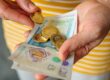 A woman holding cash in her hands.