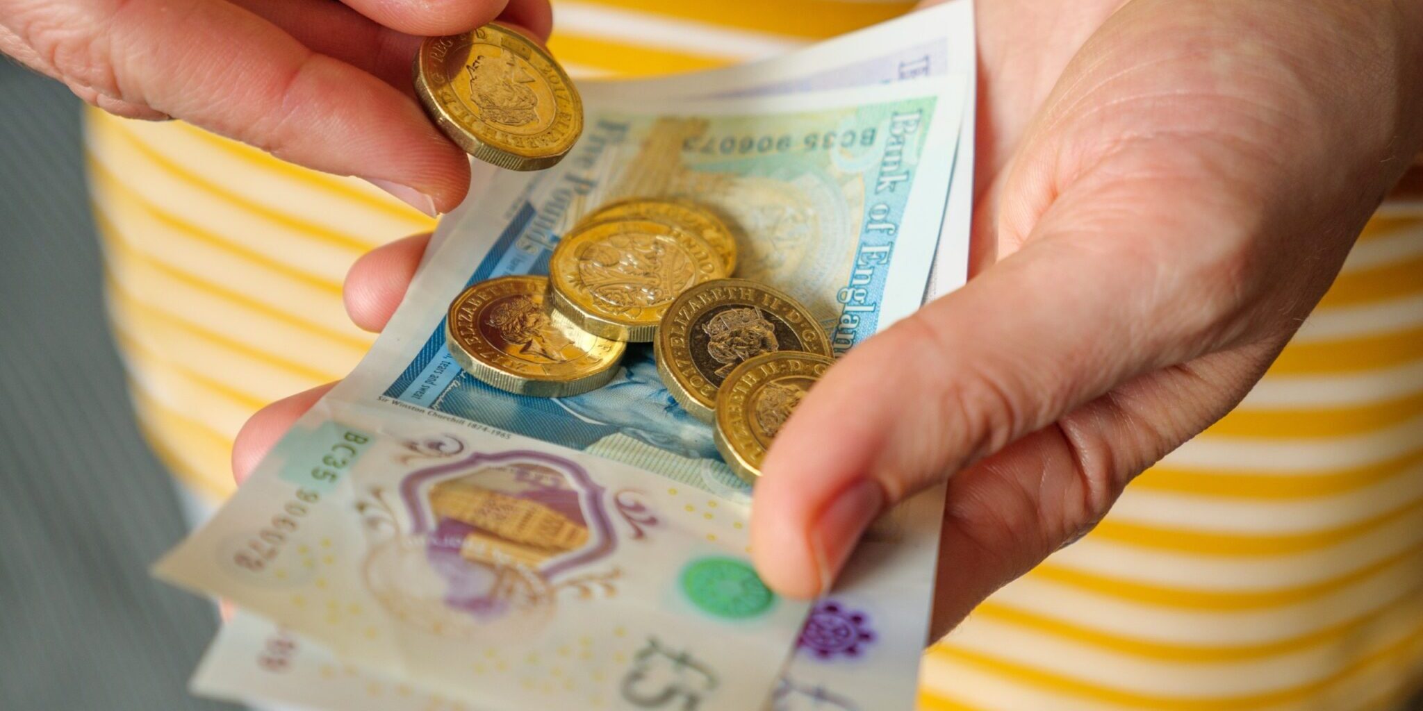 A woman holding cash in her hands.