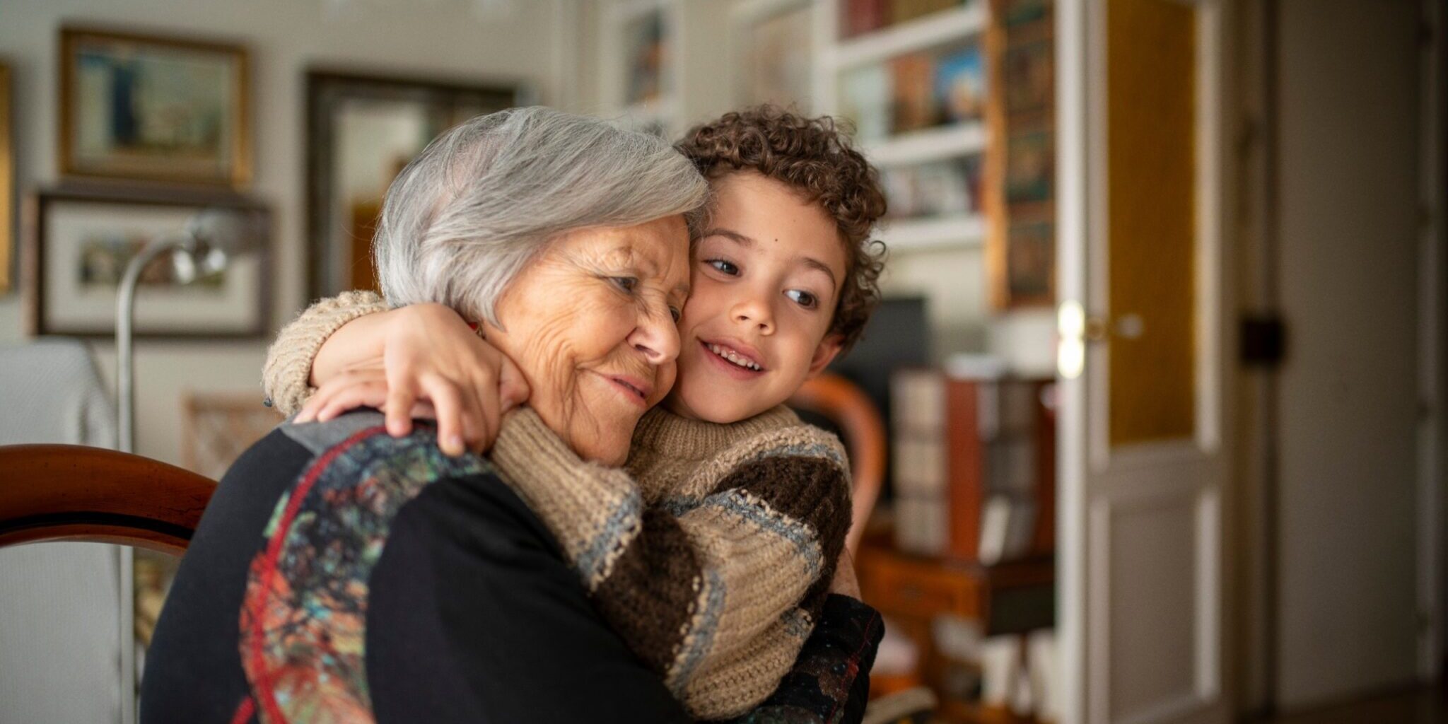 A woman hugging her grandchild.