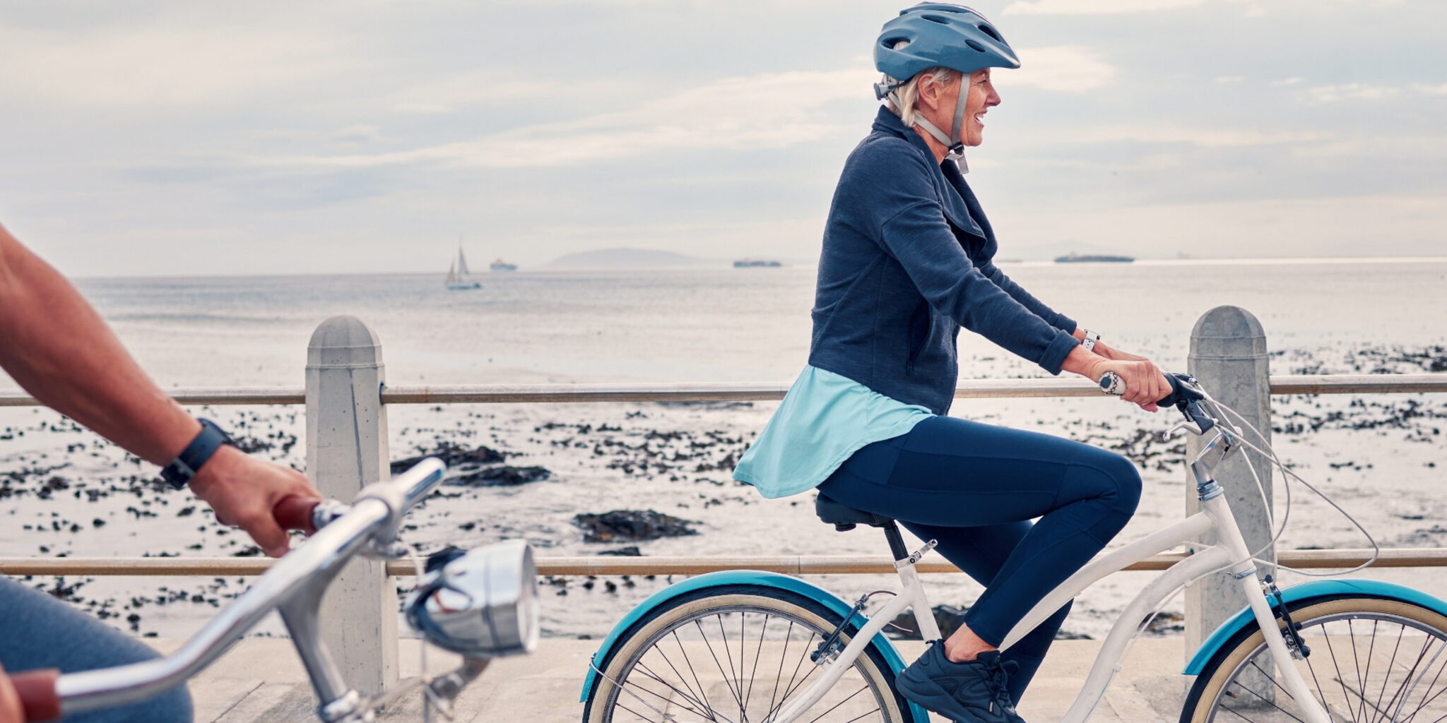21 A woman cycling along a beachfront.